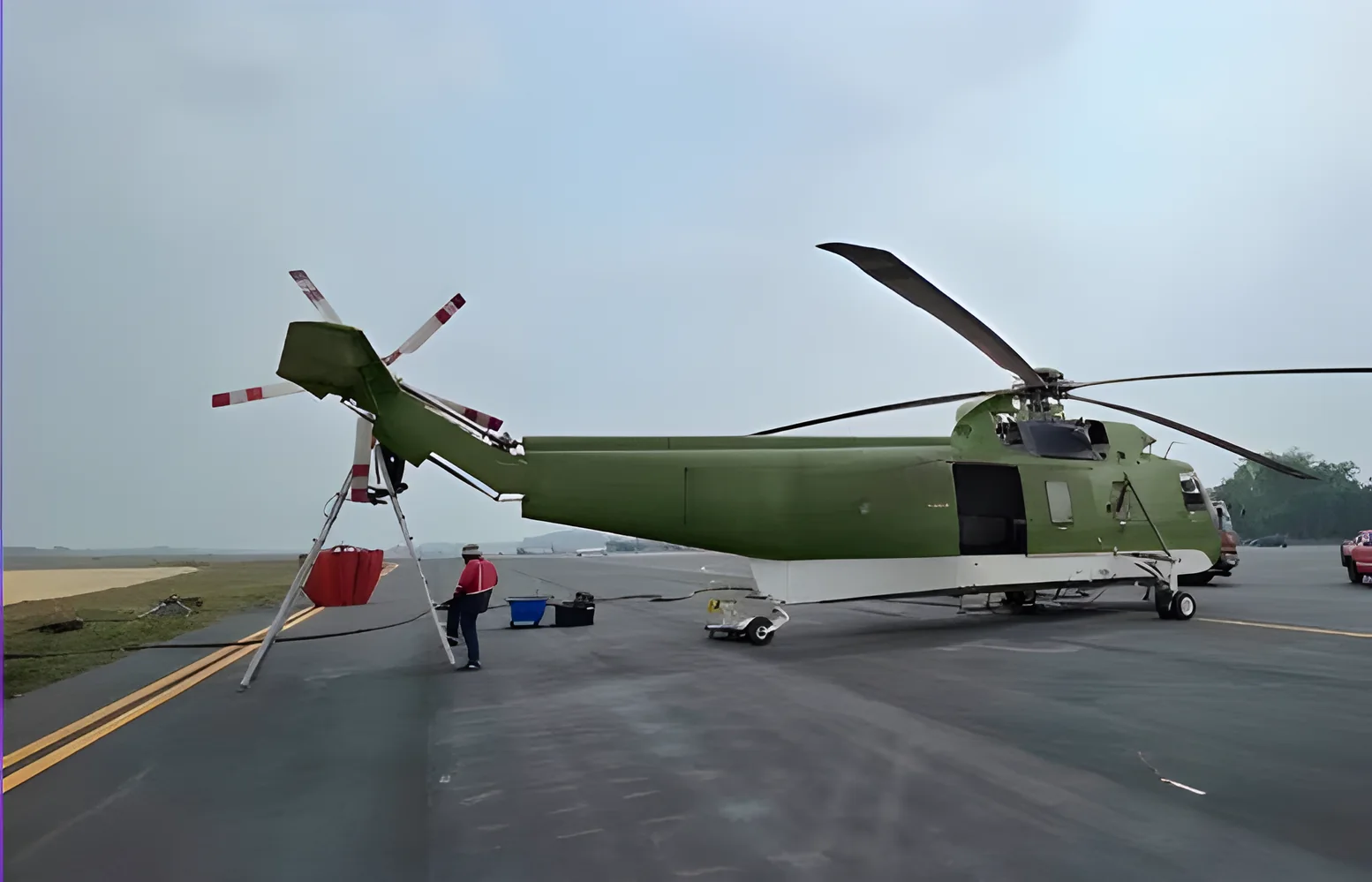 Sikorsky S-61A on the runway with support crew
